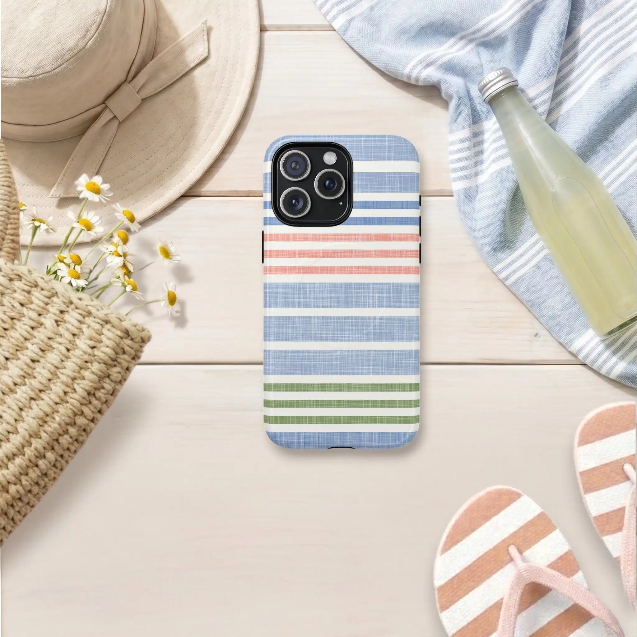 Phone case with striped pattern on a wooden surface with summer accessories.
