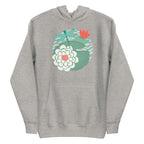 Illustrated dragonfly hovering over a green lily pad with pink and white water lily flowers on a rippled circular pond, printed on a soft premium athletic gray hoodie sweatshirt.