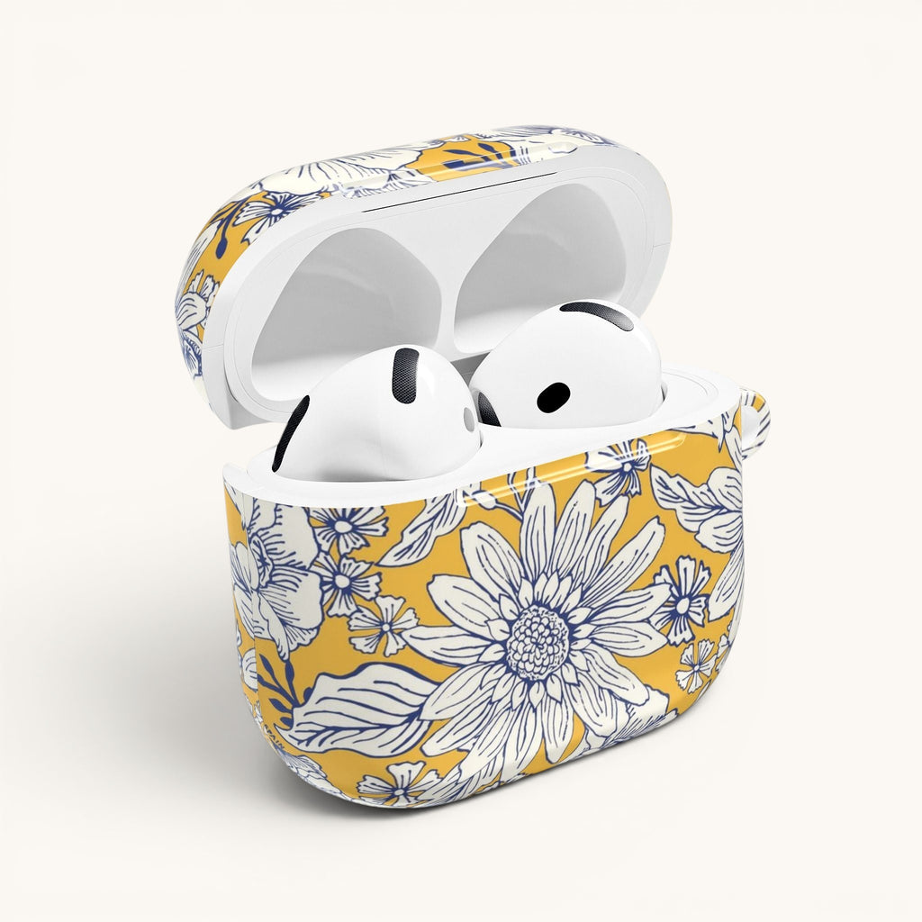 floriori Jardin Yellow AirPods case featuring a white hand drawn botanical toile print on a golden yellow glossy polycarbonate shell. Open view with earbuds.