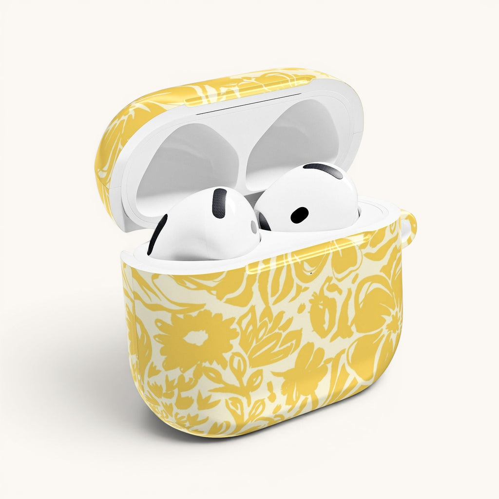 floriori AirPods case with sophisticated and energetic hand painted flower silhouettes. yellow floral on a cream glossy background. open with earbuds.