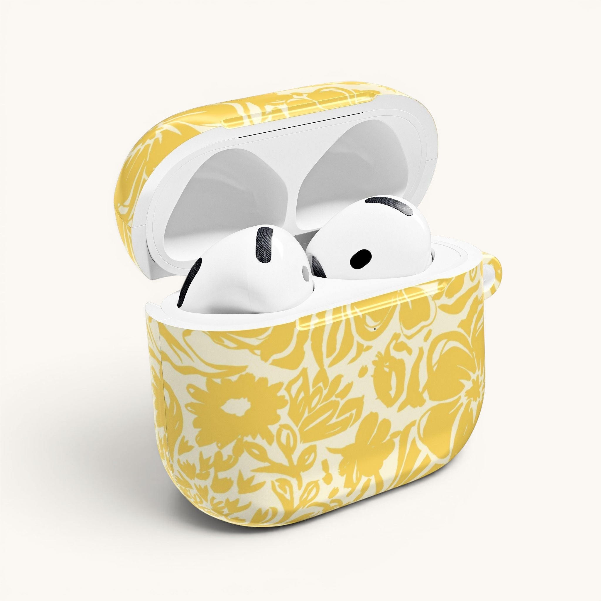floriori AirPods case with sophisticated and energetic hand painted flower silhouettes. yellow floral on a cream glossy background. open with earbuds.