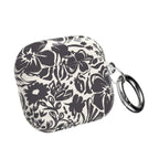 floriori AirPods case with sophisticated and energetic hand painted flower silhouettes. black floral on a cream glossy background. back view