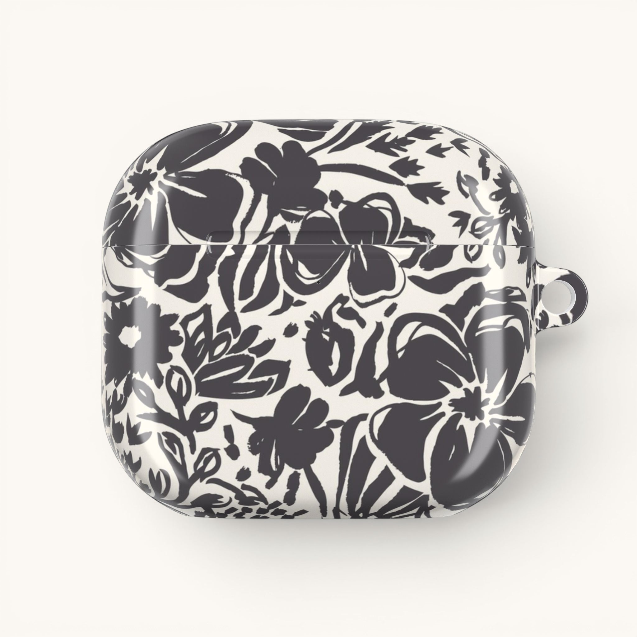 floriori AirPods Gen 4 case with sophisticated and energetic hand painted flower silhouettes. black floral on a cream glossy background.