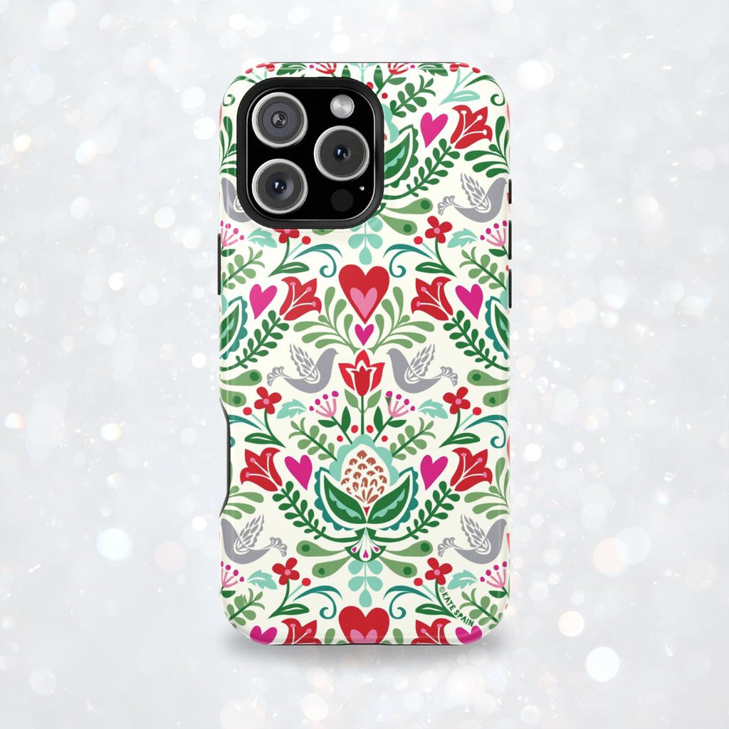 Rosemaling Tough iPhone 17 Pro Max – lifestyle/angled shot | cream, red, pink, green, gray folk art floral bird print