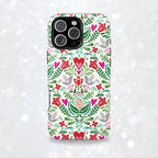 Rosemaling Tough iPhone 17 Pro Max – lifestyle/angled shot | cream, red, pink, green, gray folk art floral bird print