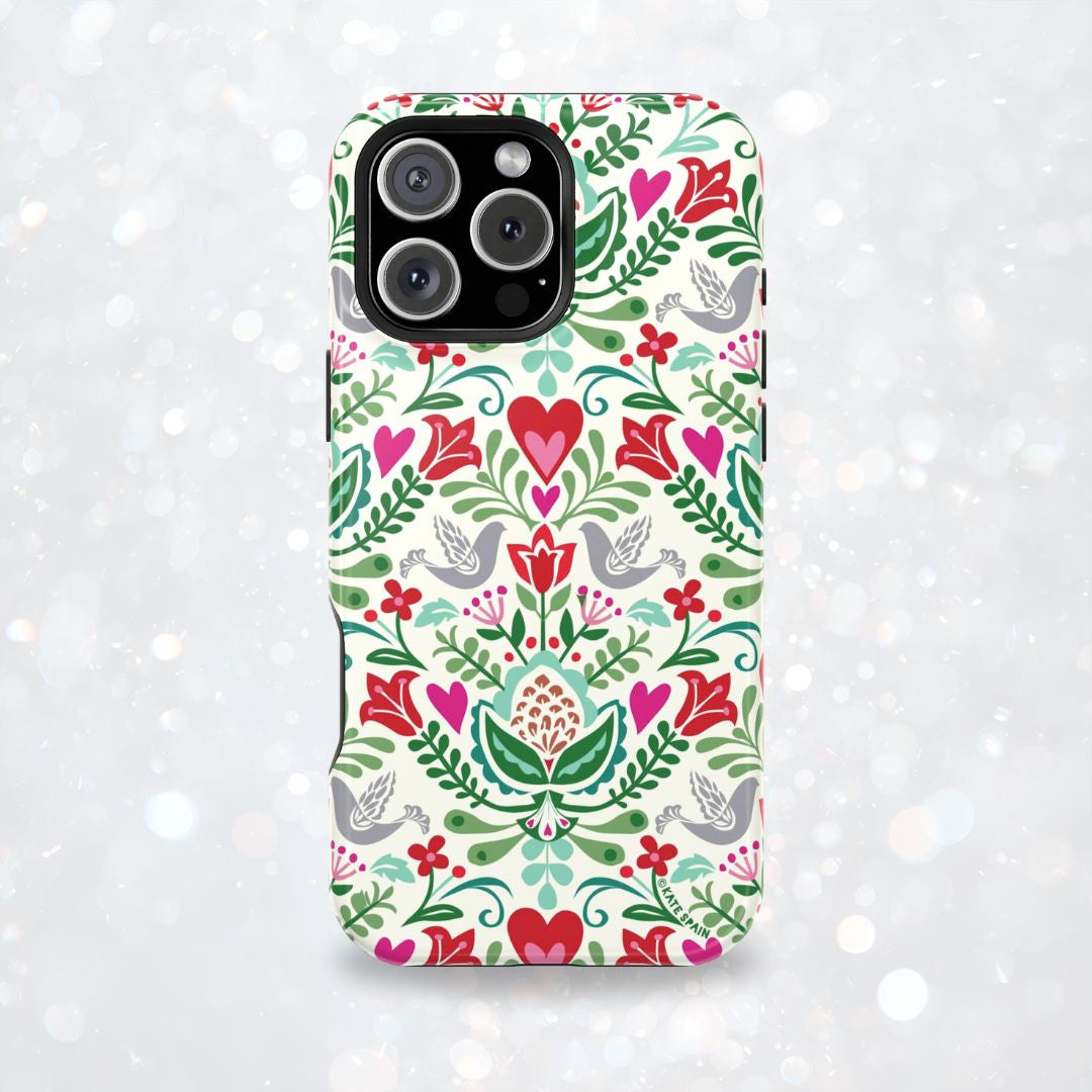 Rosemaling Tough iPhone 17 Pro Max – lifestyle/angled shot | cream, red, pink, green, gray folk art floral bird print
