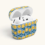 AirPods Gen 4 case with open lid, showing inside white ear buds – Glossy | golden yellow sunflowers on periwinkle blue ground