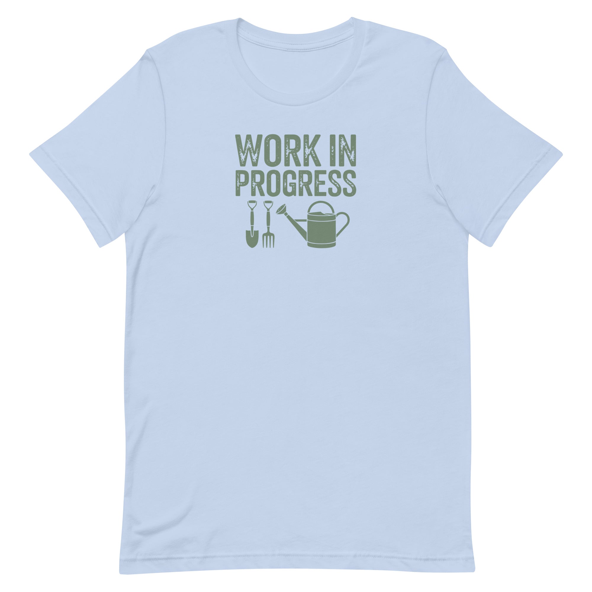 “Work in Progress” gardening graphic with shovel, pitchfork, and watering can printed in sage green on a soft baby blue colored crewneck t-shirt.