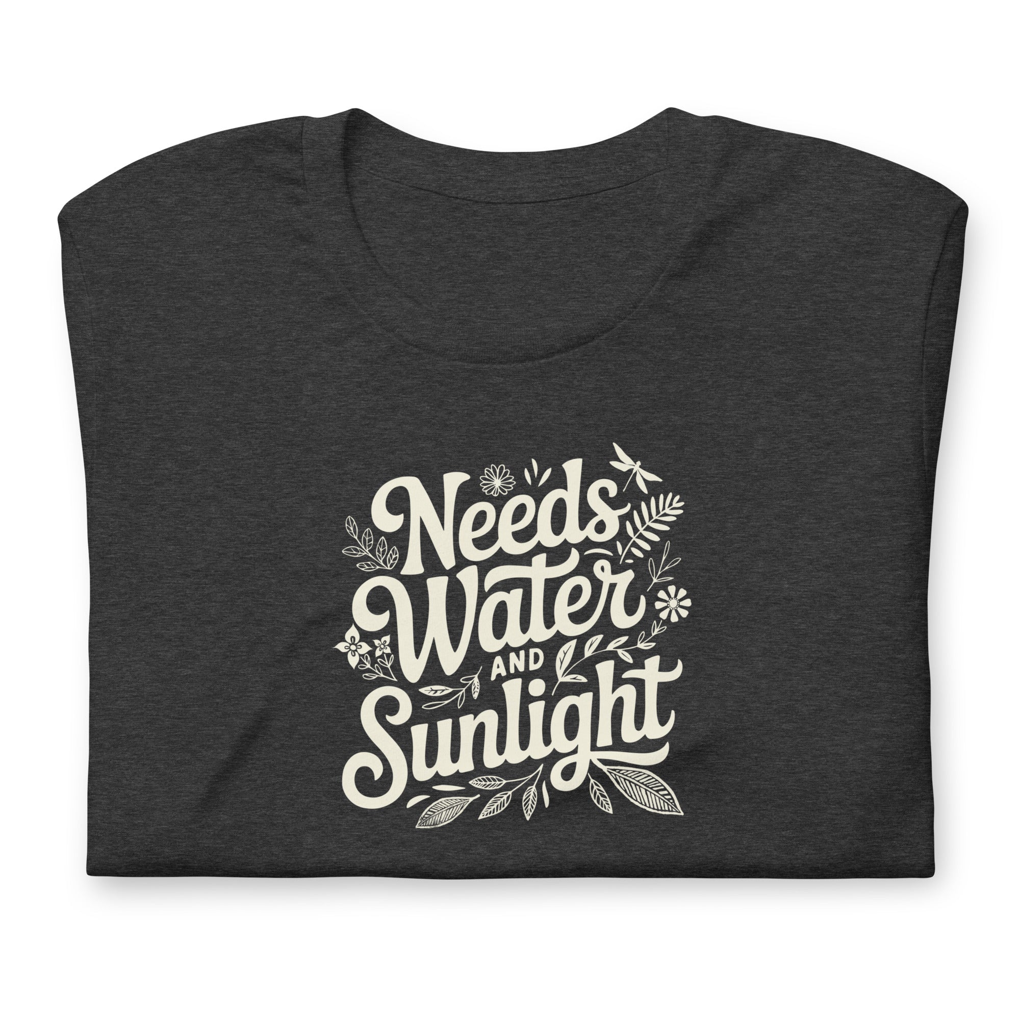 Dark charcoal gray heather colored crewneck t-shirt with white words that say 'Needs Water and Sunlight' in script style text with dragonfly, flower and leaf illustrations around the words.
