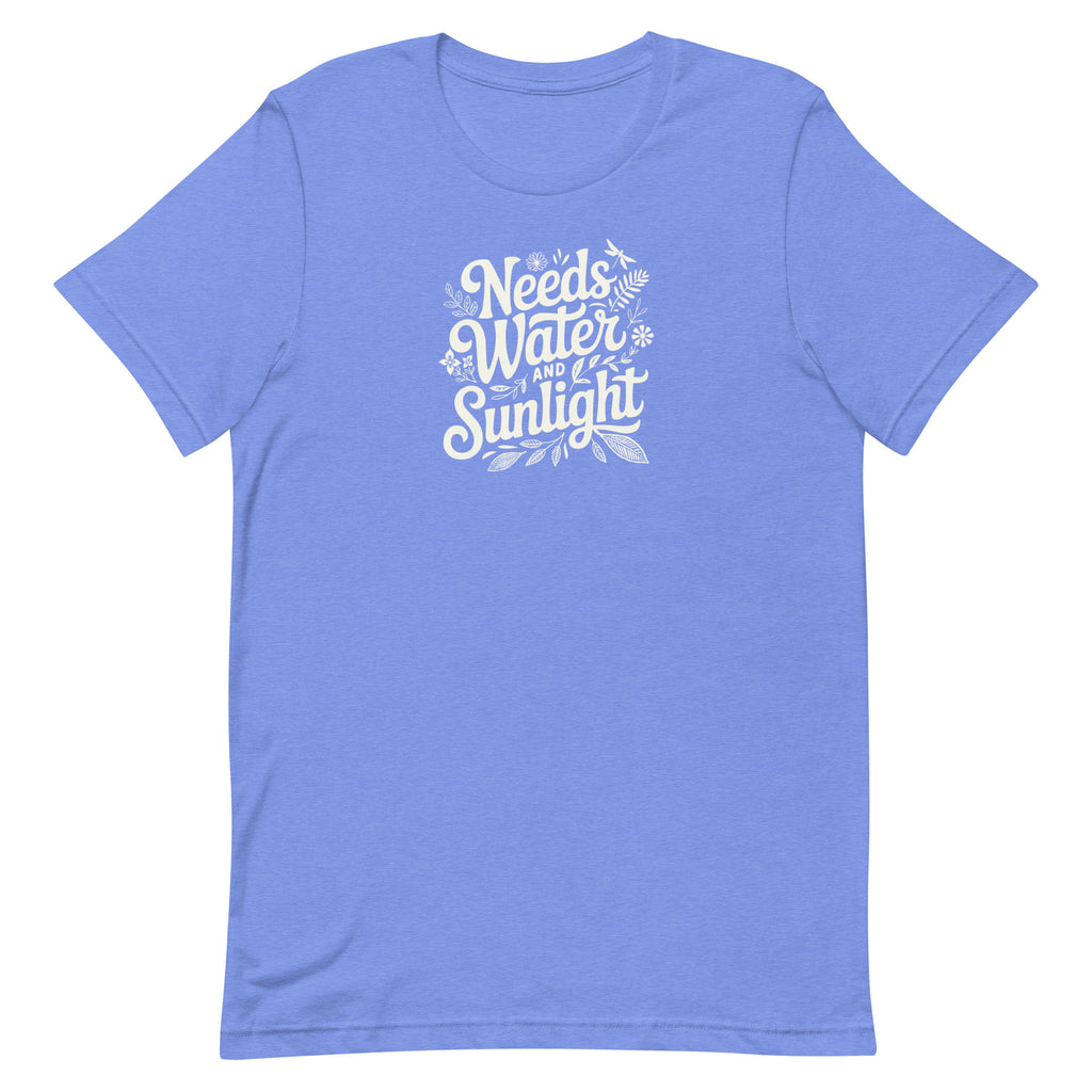 Bright columbia blue colored crewneck t-shirt with white words that say 'Needs Water and Sunlight' in script style text with dragonfly, flower and leaf illustrations around the words.