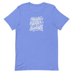 Bright columbia blue colored crewneck t-shirt with white words that say 'Needs Water and Sunlight' in script style text with dragonfly, flower and leaf illustrations around the words.