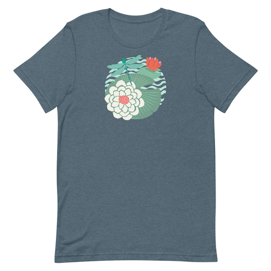 Illustrated dragonfly hovering over a green lily pad with pink and white water lily flowers on a calm pond, printed on a soft gray-blue colored premium quality crewneck t-shirt.
