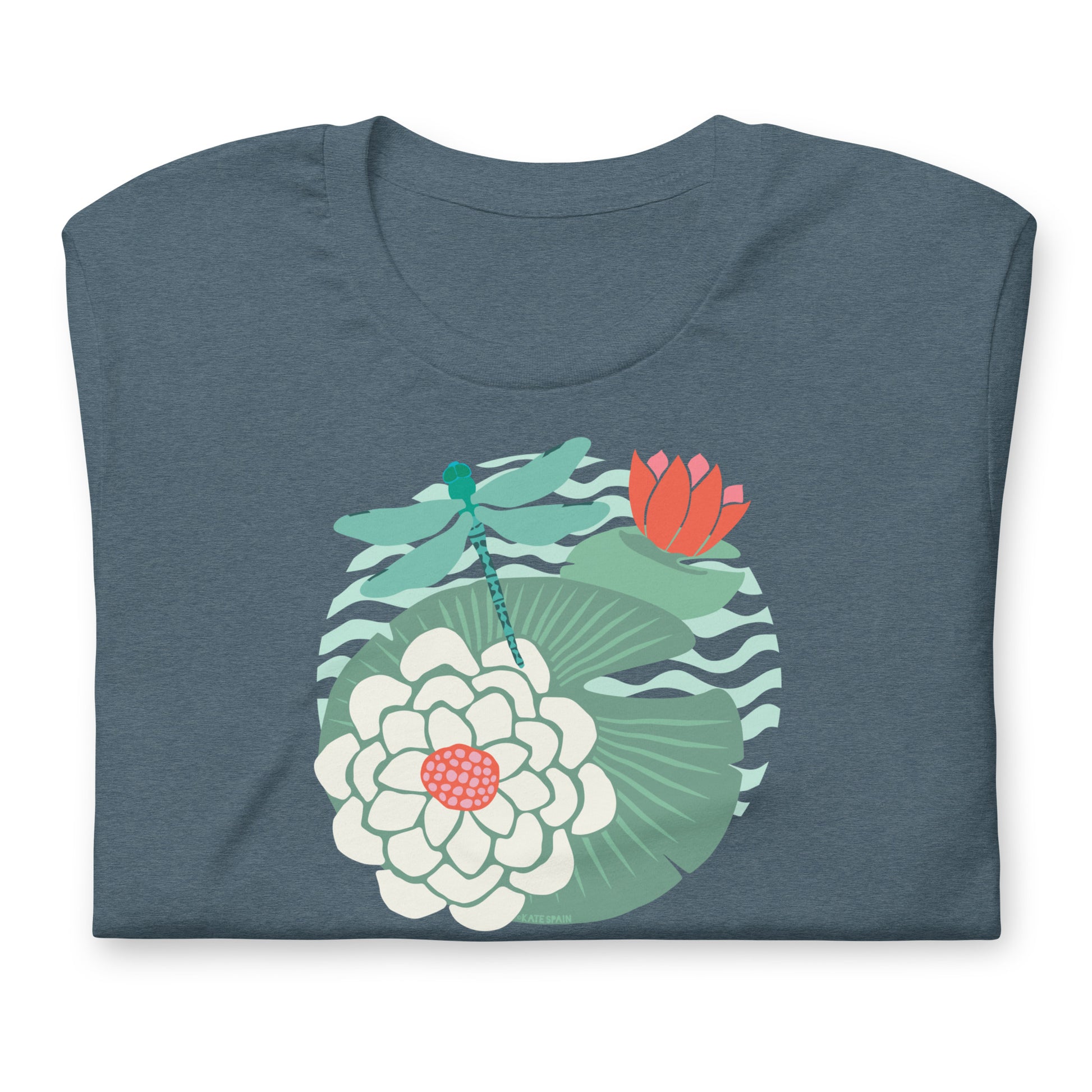 Illustrated dragonfly hovering over a green lily pad with pink and white water lily flowers on a calm pond, printed on a soft gray-blue colored premium quality crewneck t-shirt. Shown folded for scale.