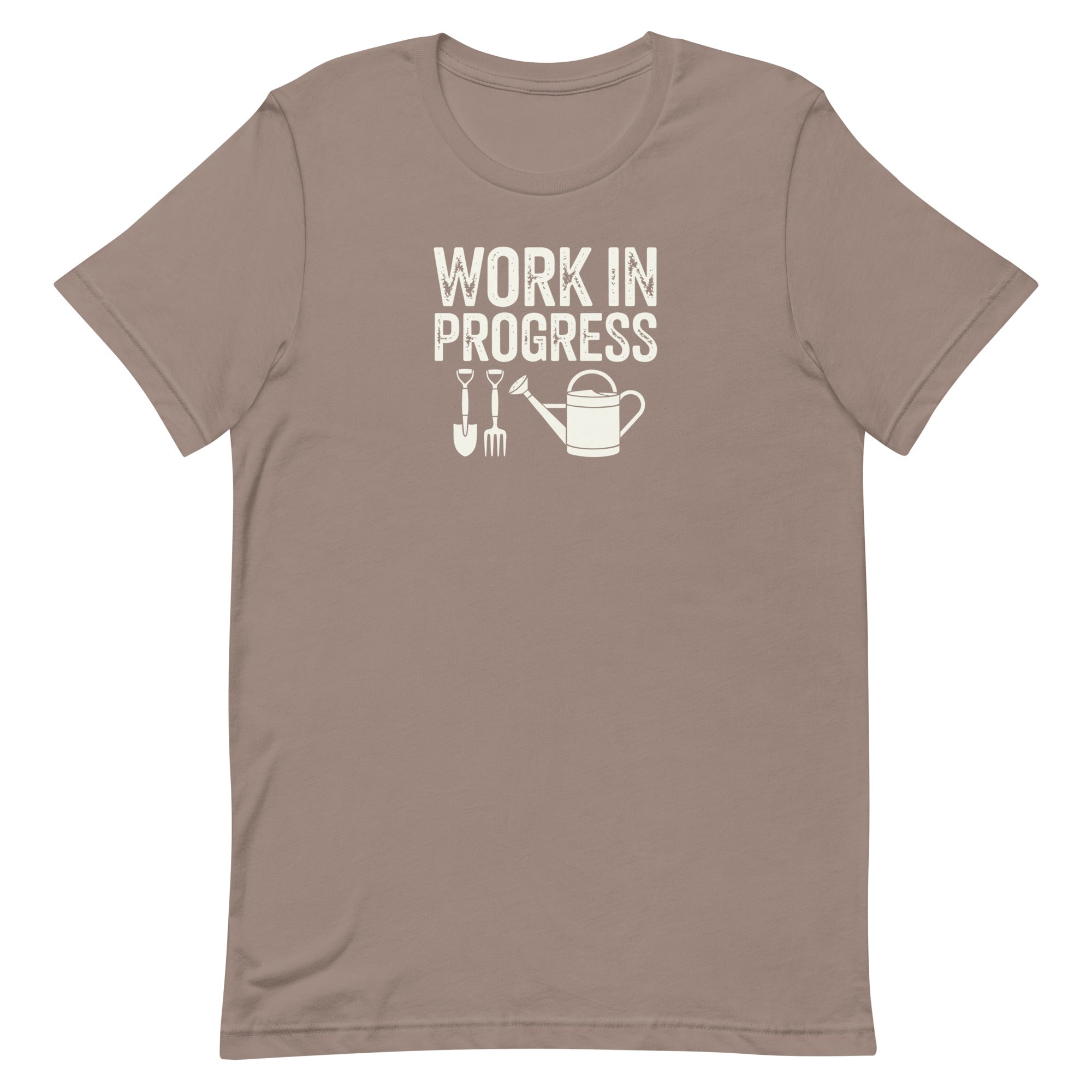 “Work in Progress” gardening graphic with shovel, pitchfork, and watering can printed in sage green on a soft stone taupe colored crewneck t-shirt.