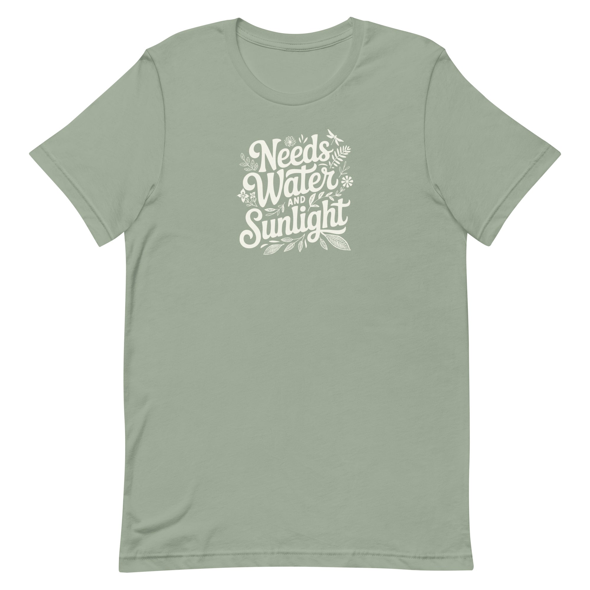 Pale sage green colored crewneck t-shirt with white words that say 'Needs Water and Sunlight' in script style text with dragonfly, flower and leaf illustrations around the words.