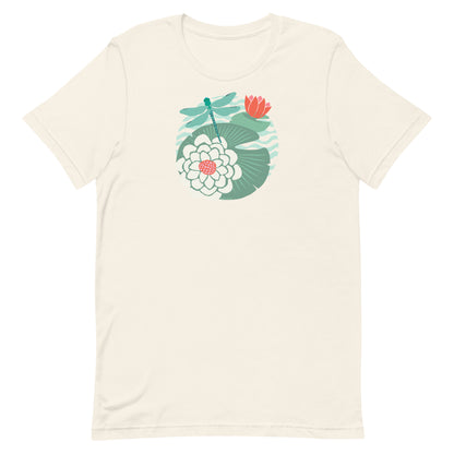 Illustrated dragonfly hovering over a green lily pad with pink and white water lily flowers on a calm pond, printed on a soft pale off-white cream colored premium quality crewneck t-shirt.