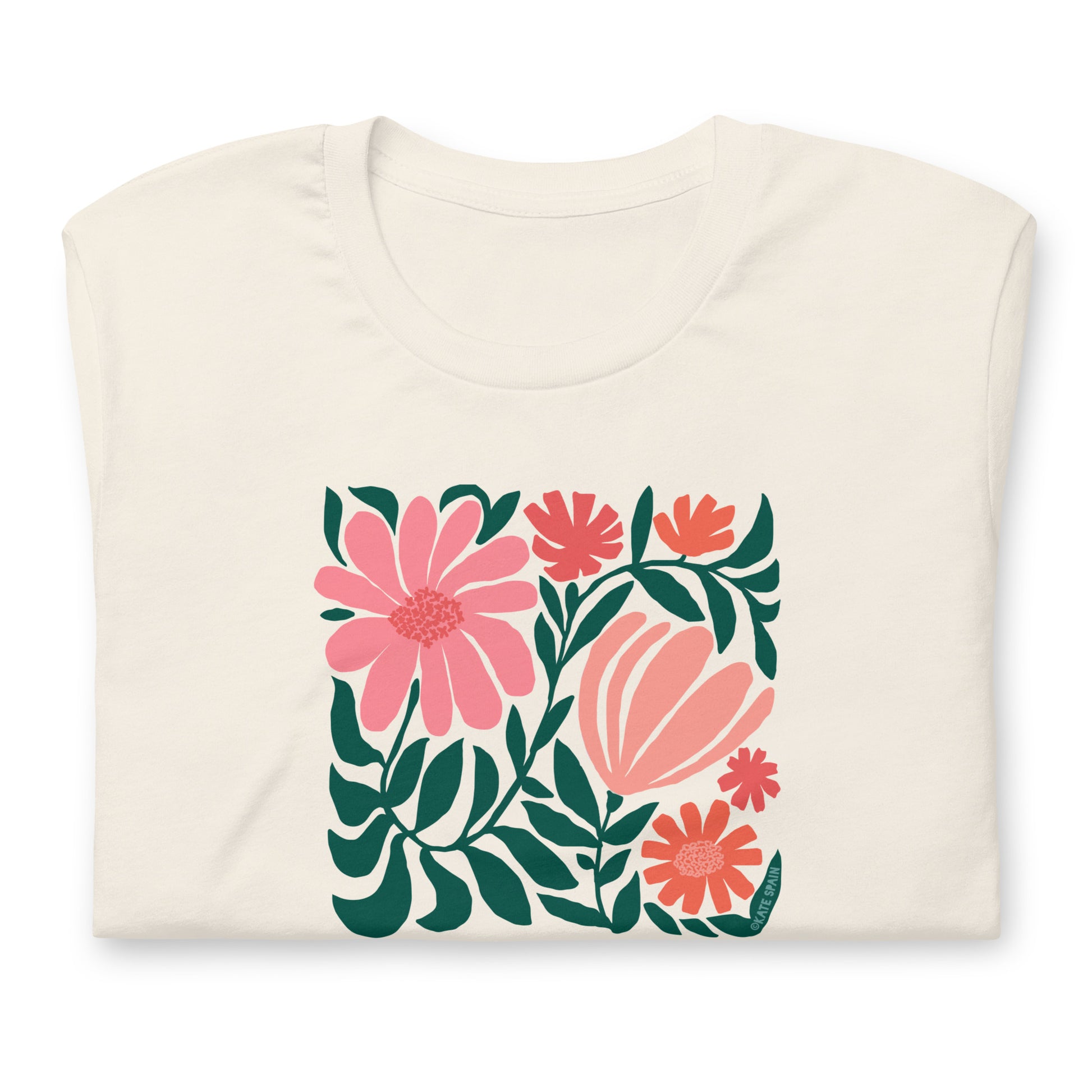 Minimalist floral graphic design with modern botanical illustrations printed on an pale off-white cream colored premium crewneck tshirt. Shown folded for scale.